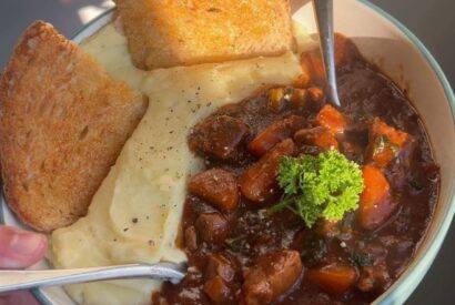 Thumbnail for Slow-cooked beef stew served with mashed potatoes and buttered sourdough toast.
