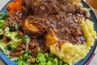 Thumbnail for Mince and cheesy herb dumplings with five vegetables and sweet pickled onions in the gravy.
