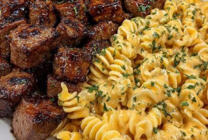 Thumbnail for Juicy, Glazed Steak Bites Served With Creamy, Cheesy Rotini Pasta.