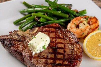 Thumbnail for Grilled T-bone Steak With Garlic Butter, Shrimp And Sautéed Green Beans